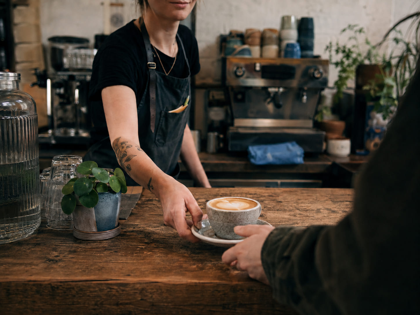 A barista serving a customer in an independent coffee shop